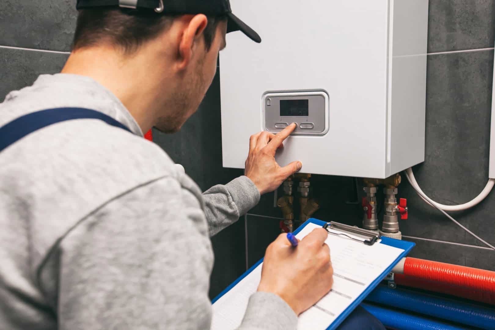 Gas engineer working on a boiler and central heating system in Dorking